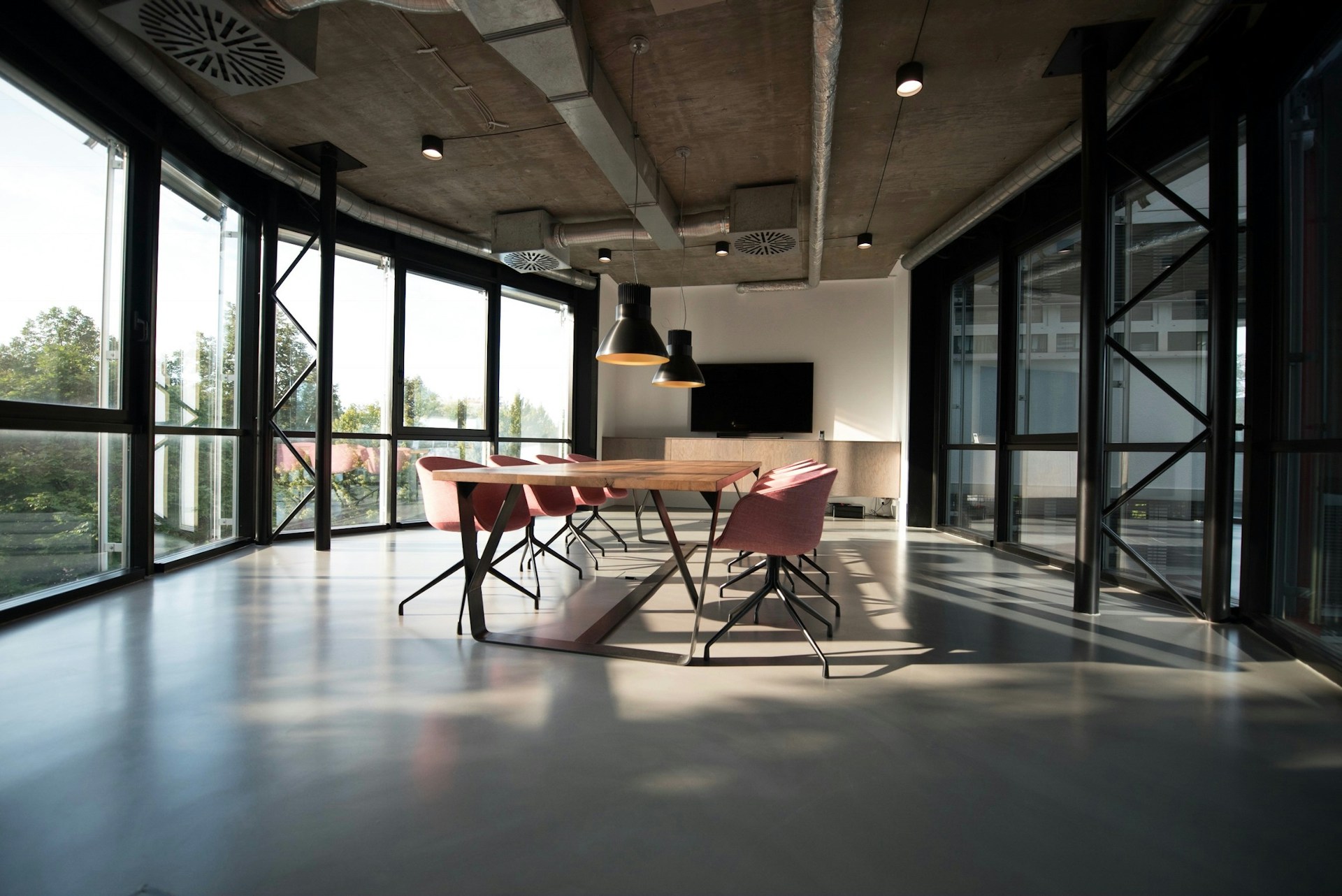 Louvred windows with morning sea light across a Katong studio table