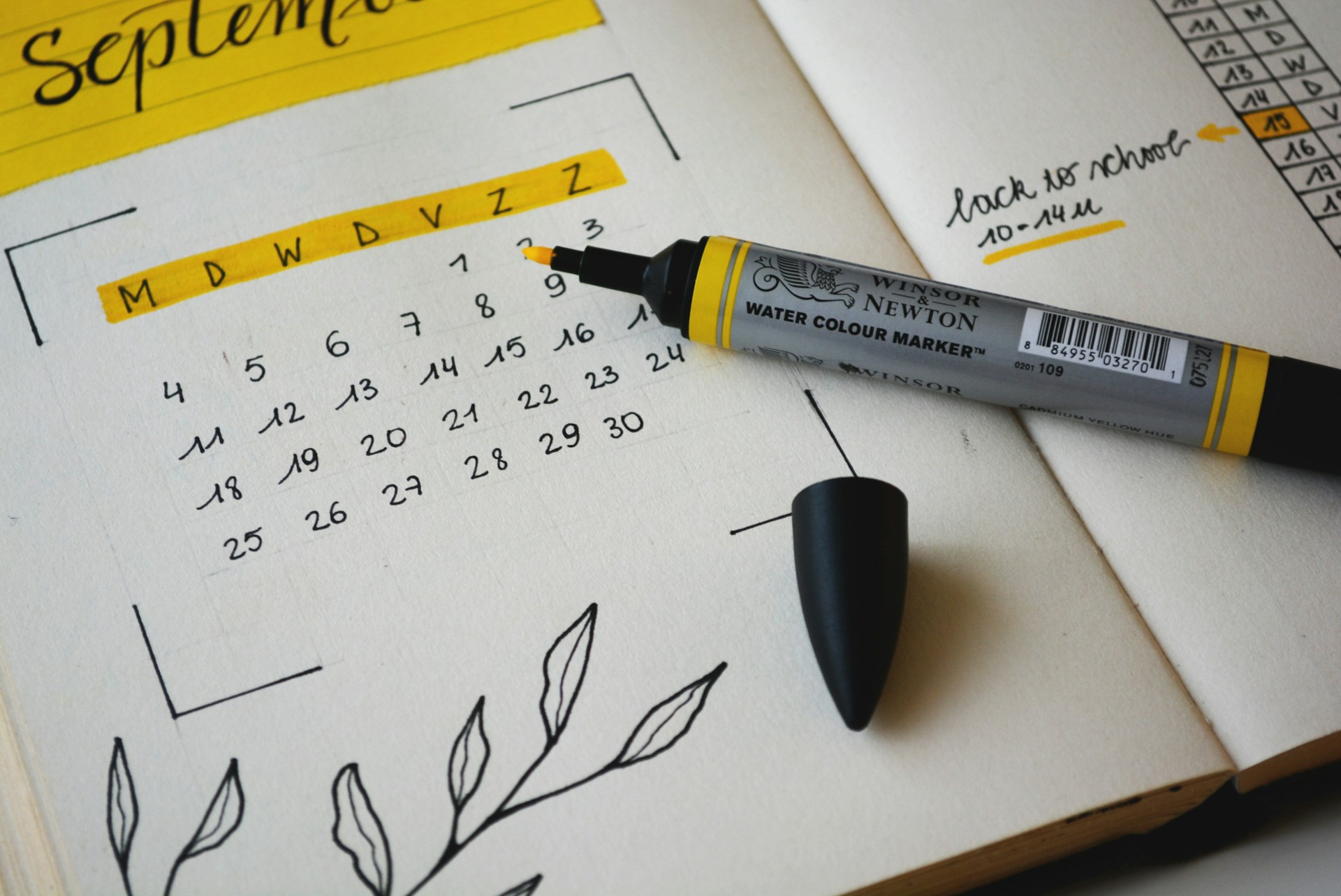 Printed calendar on a table beside annotated index tabs