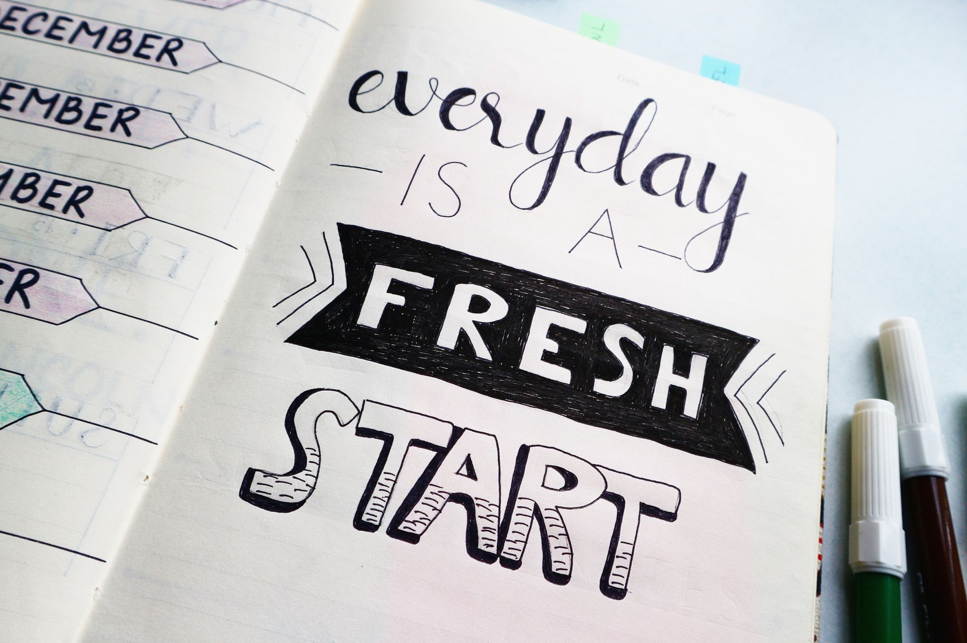 Open notebook with pen beside a quarter grid printout